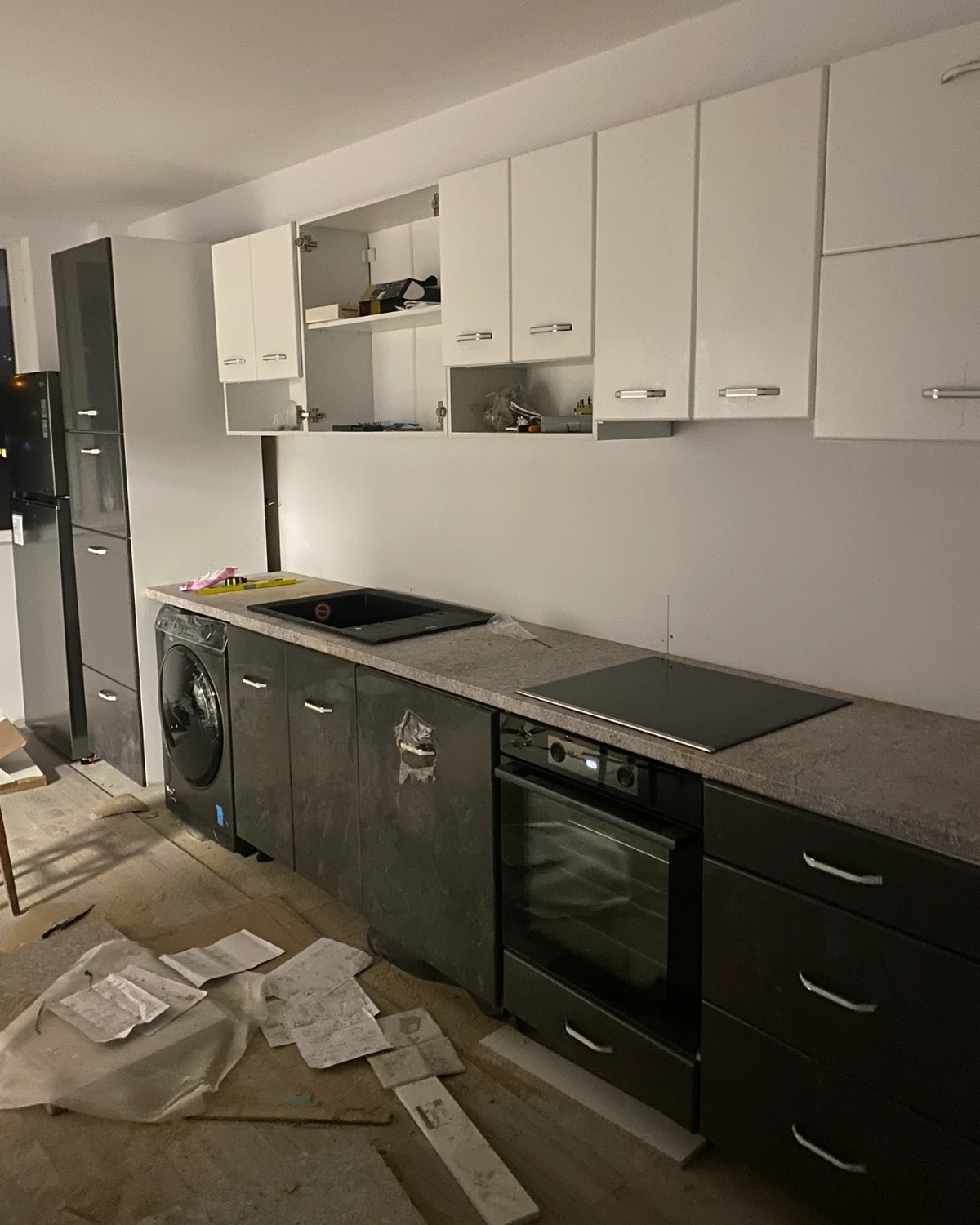 The kitchen during fitting: some doors not yet on, packaging on the floor
