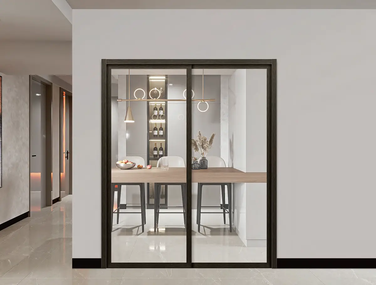 A dark-framed sliding door to a dining area